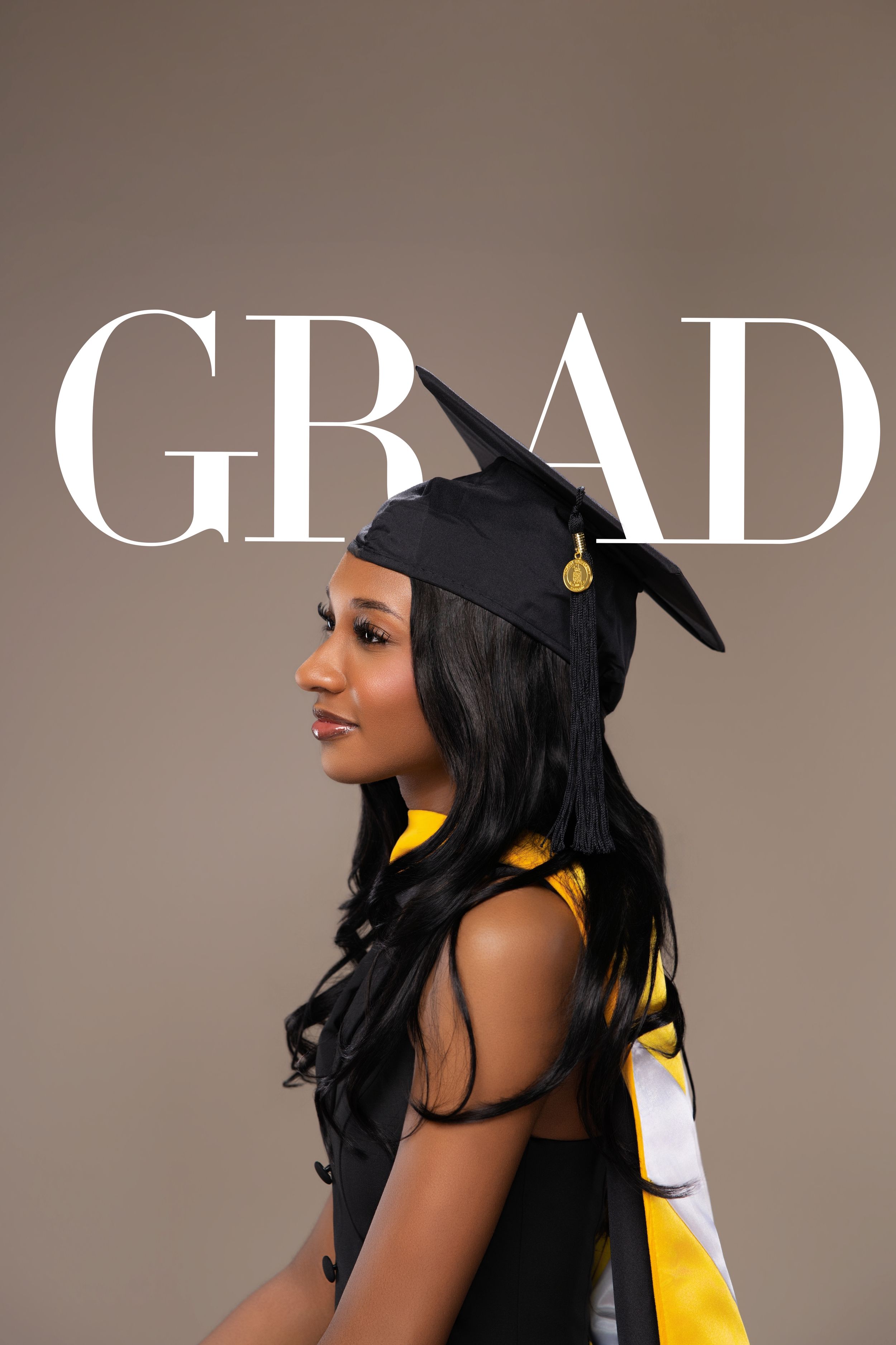 Graduate in black cap and yellow sash poses in profile with GRAD text overlay on taupe background.