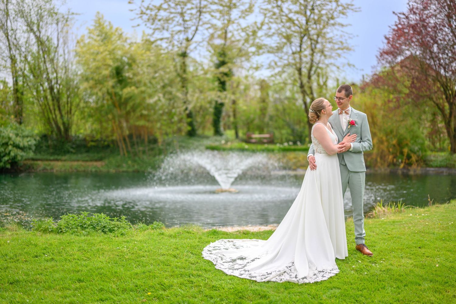 A romantic wedding couple poses in a series of elegant shots under stone archways at a historic European castle.