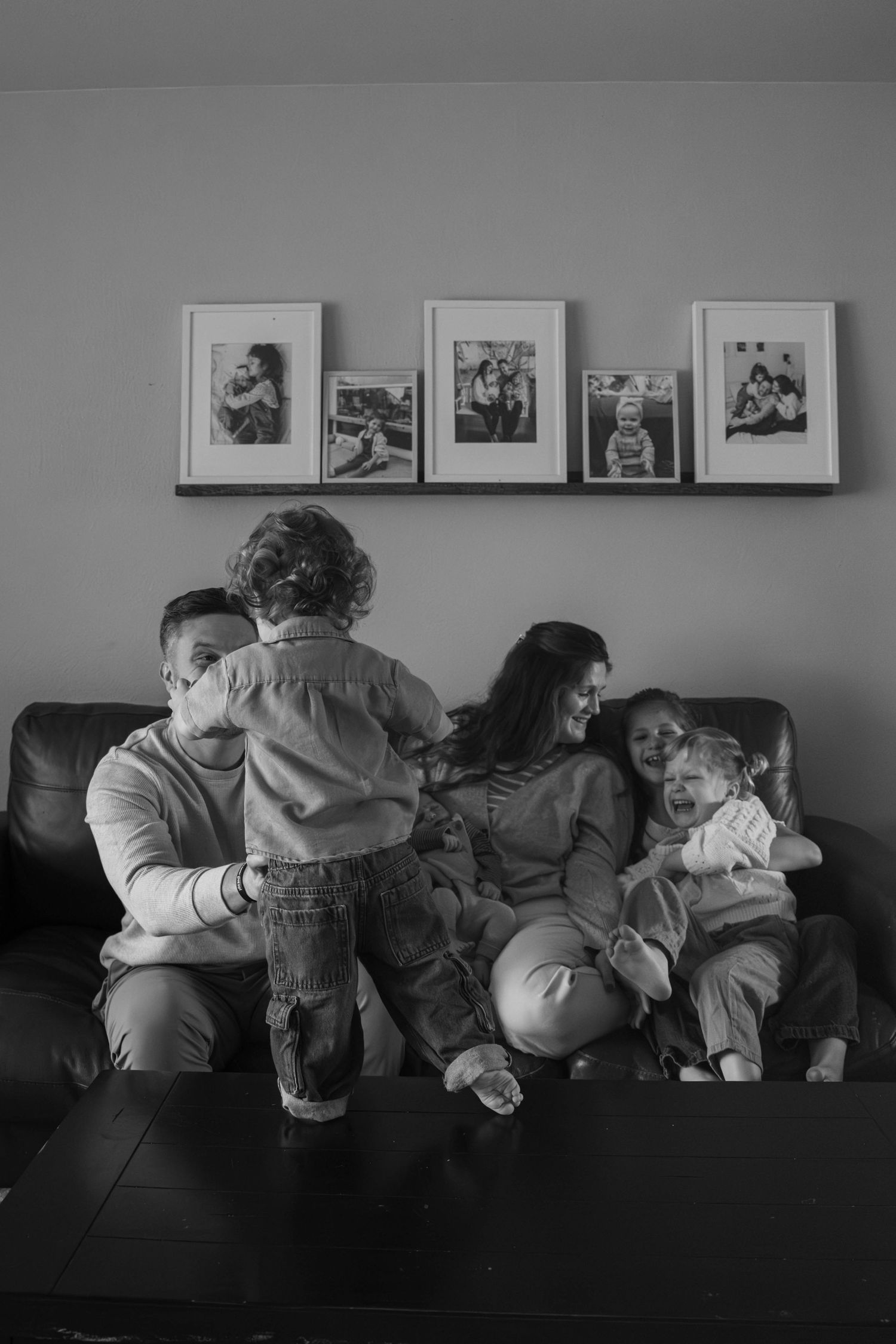 Playful family moment during an in-home lifestyle photography session in Spokane, Washington with young children.