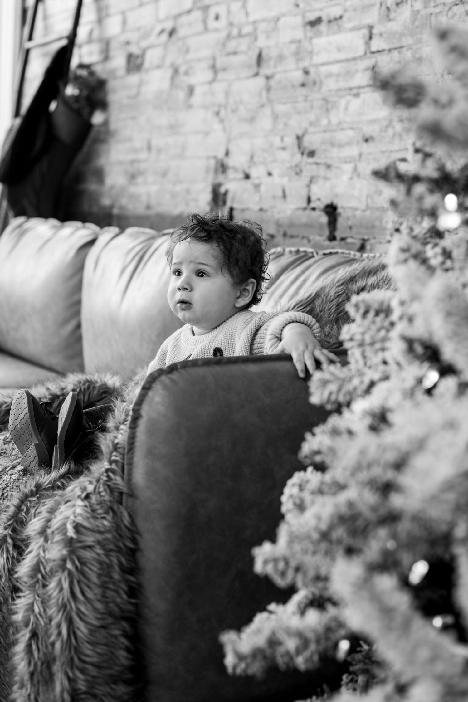 "Baby boy smiling for Cincinnati family photos, showing his sweet personality and bright holiday spirit.
