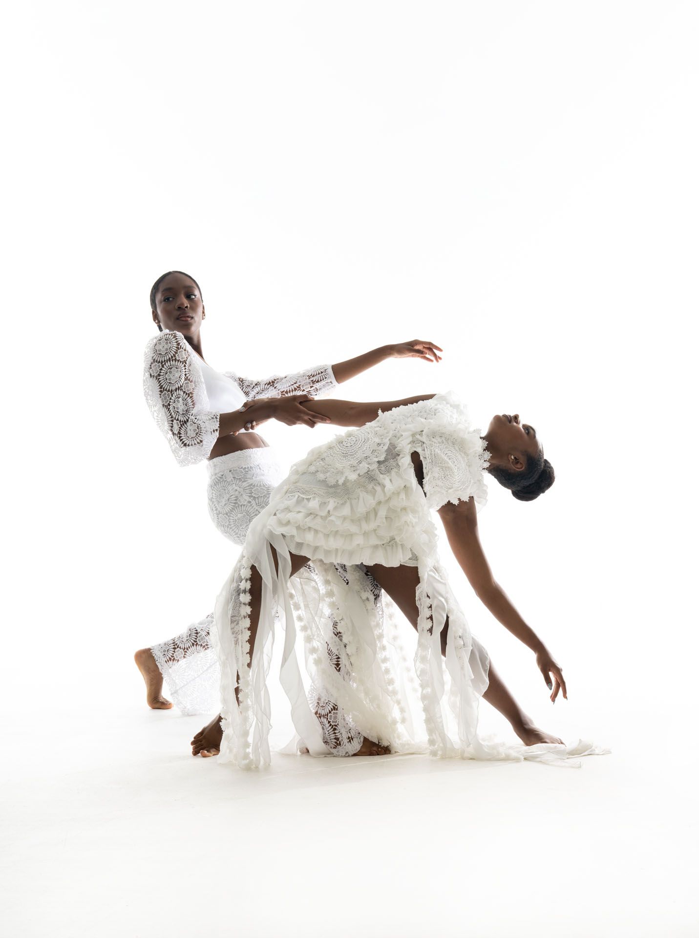 A sequence of three artistic dance poses performed in a white dress against a minimalist white backdrop.