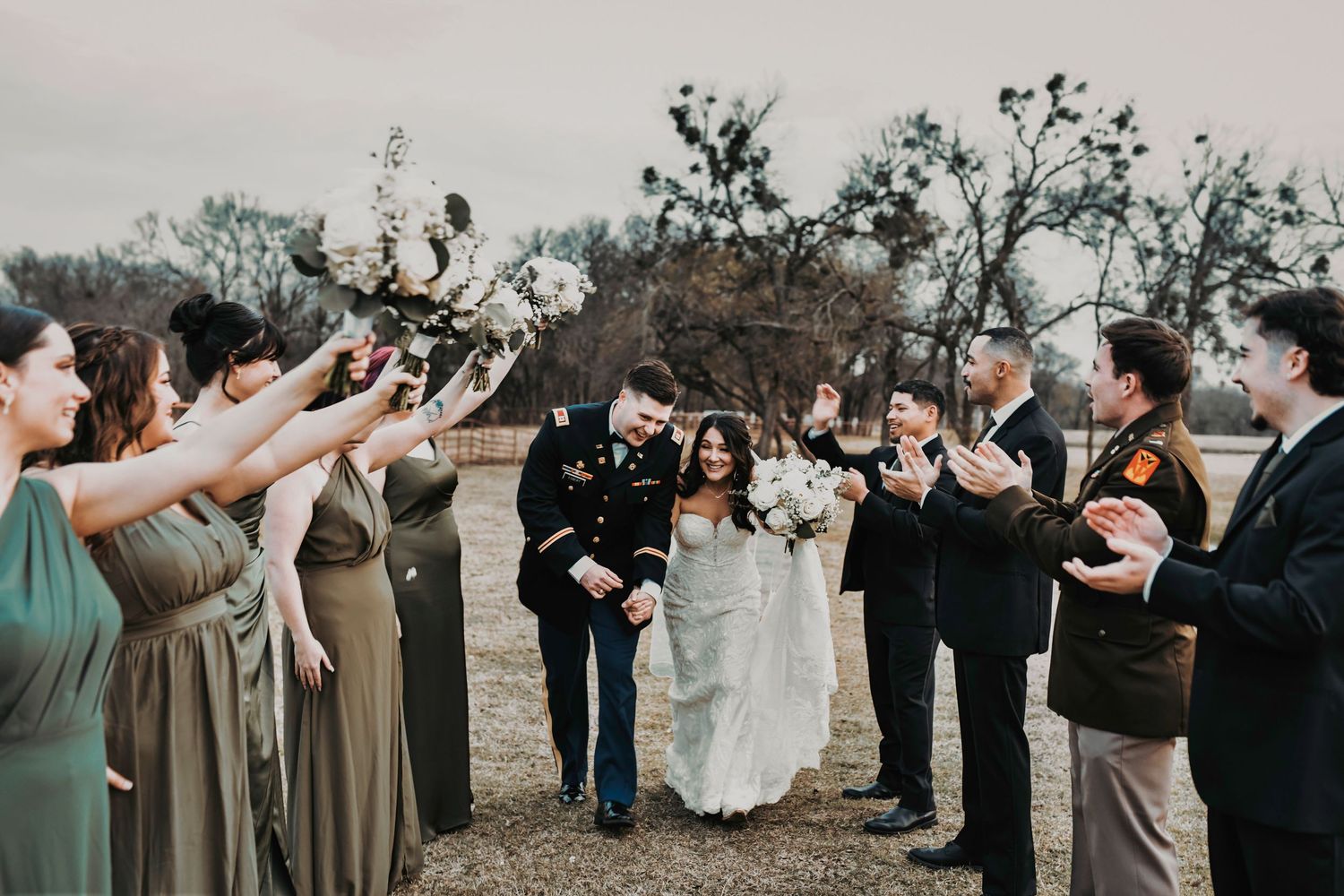 Bridal party and groomsmen cheering and celebrating in a lively, playful wedding moment.