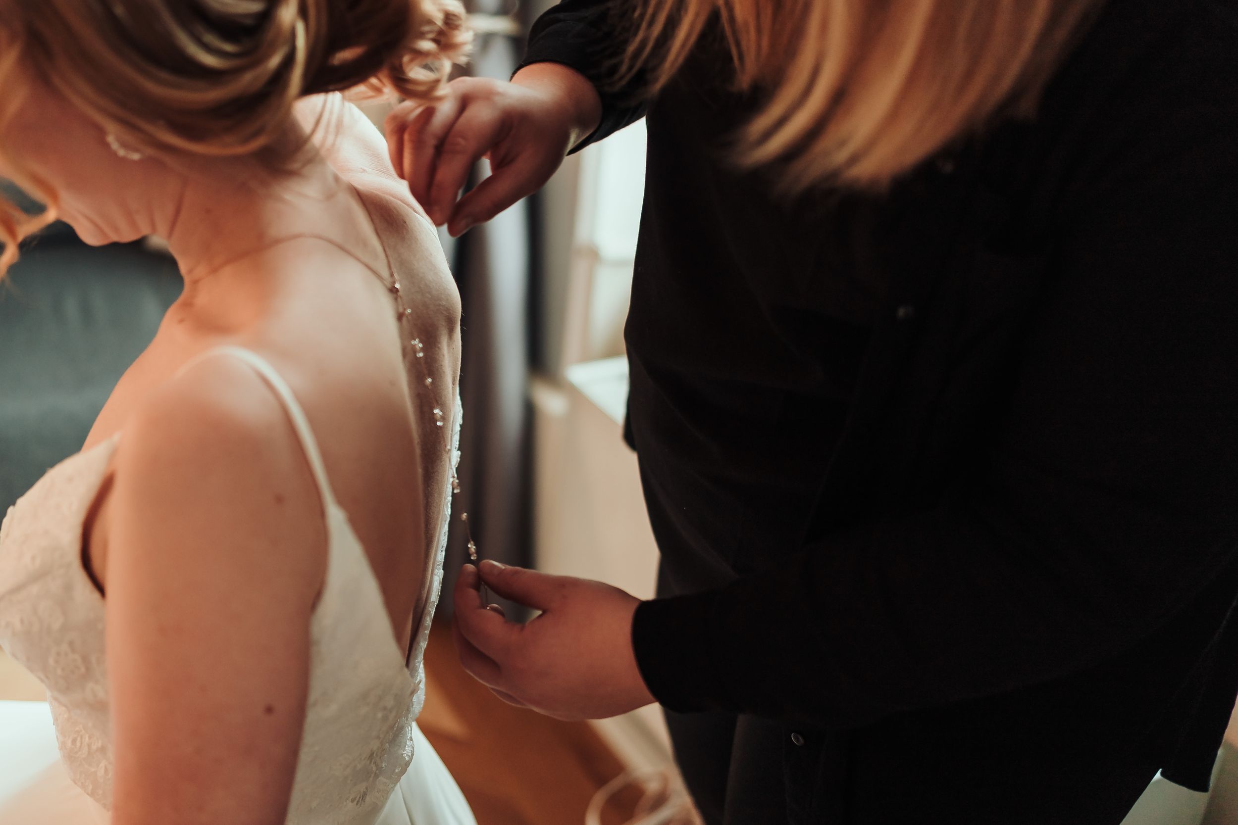 Couple shares intimate moment during wedding ceremony as they exchange rings and vows at altar.