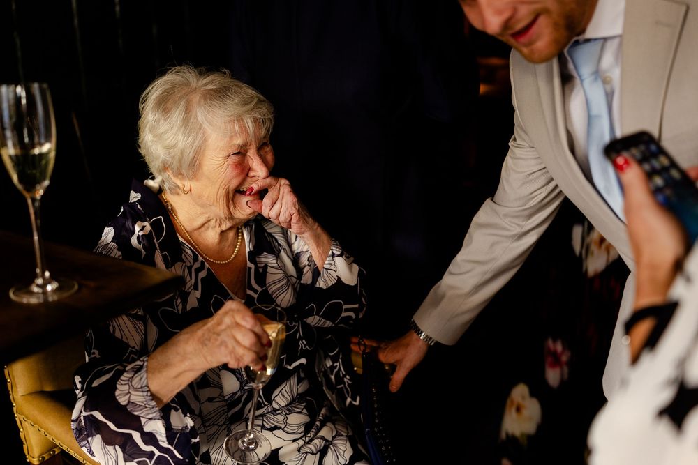 Guests enjoying drinks and conversation at an evening celebration.