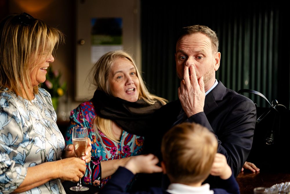 Candid moments captured during a wedding reception showing natural reactions and laughter.