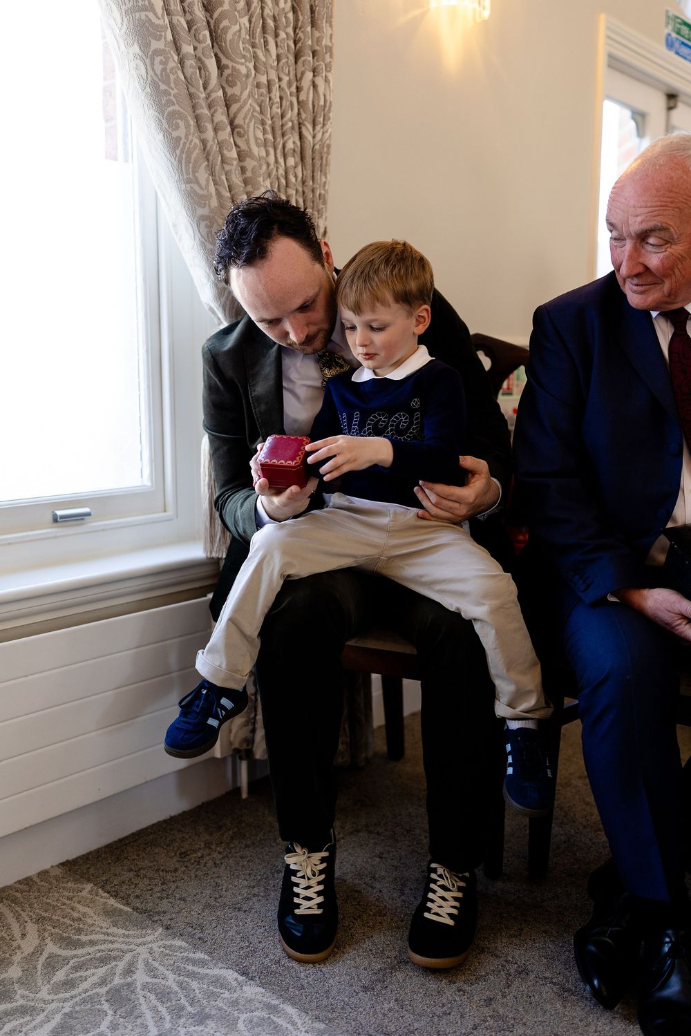 A tender interaction between generations sitting together on a bench.