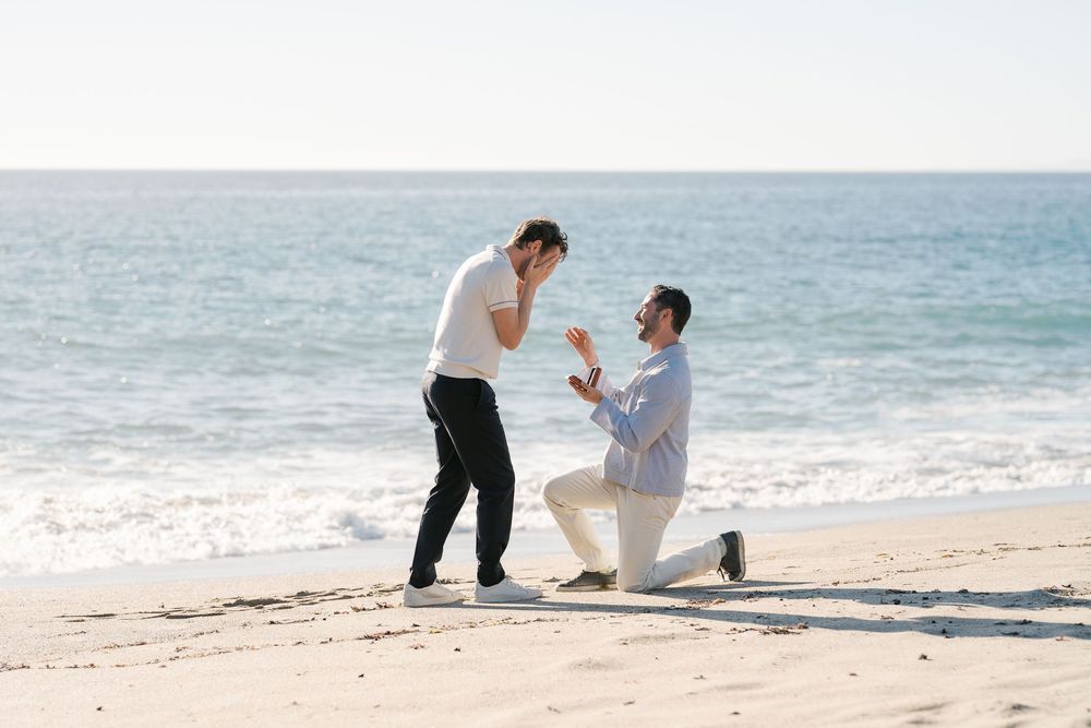 A romantic beach proposal unfolds in a series of photos showing a couple on white sand with ocean waves in the background.