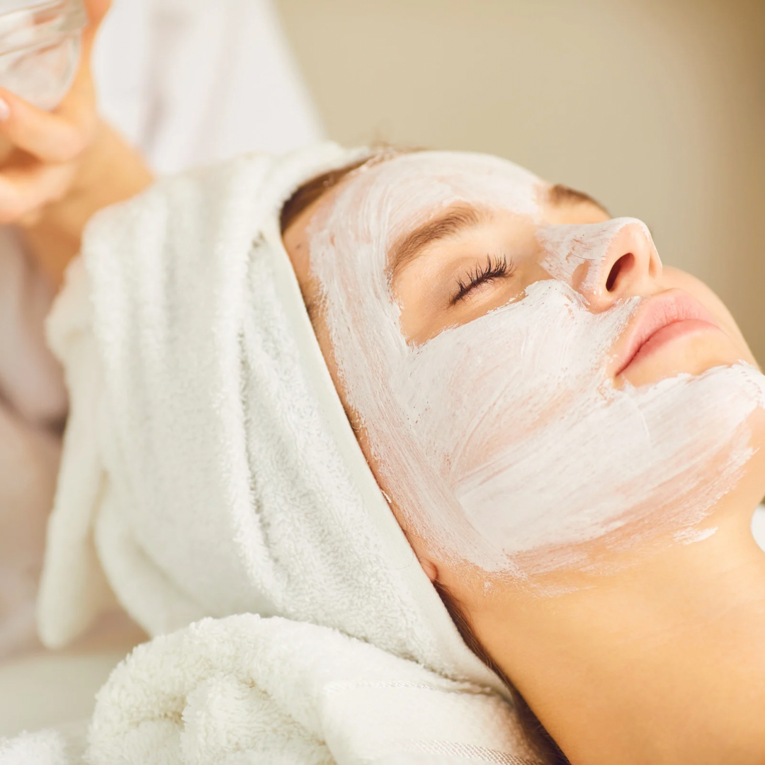 Close-up shots of a white facial mask treatment being applied in a spa setting.