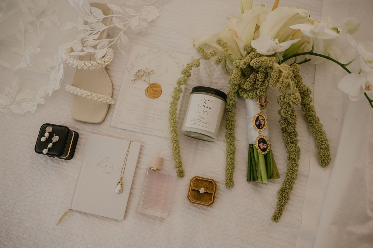 Elegant wedding invitation suite with floral elements and gold accents displayed on a light neutral background.