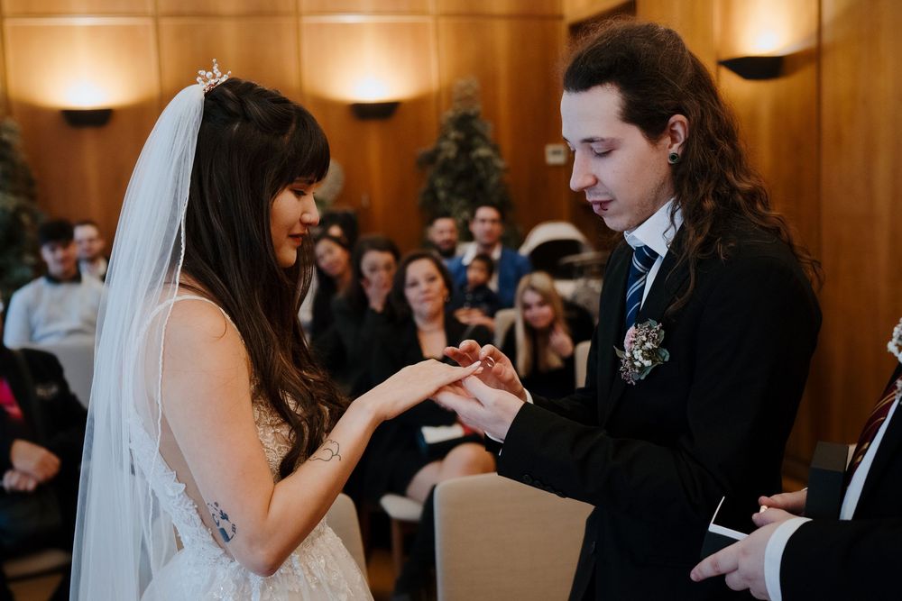 Bride and groom share an intimate moment during their first dance at an elegant indoor wedding reception.
