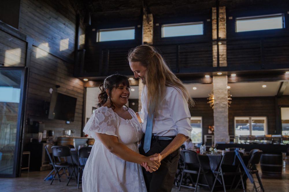 People gathered in a modern venue with high ceilings and industrial styling.
