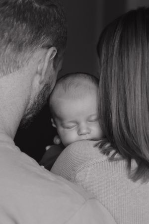 Black and white photo sequence showing tender family moments on a couch.