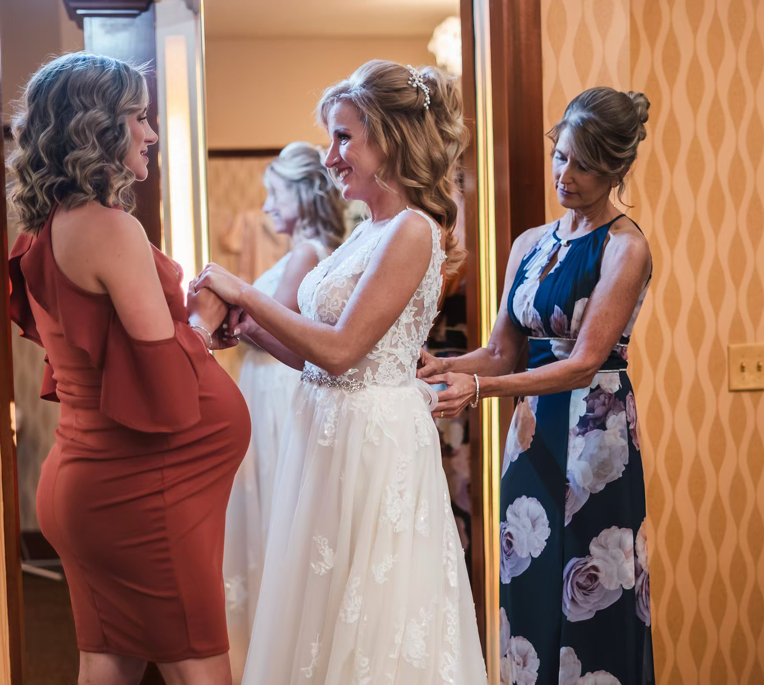 A sequence of photos showing someone helping another person get dressed in a formal white gown.