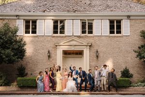 A series of wedding party photos taken outside a stone building with classic architectural details.