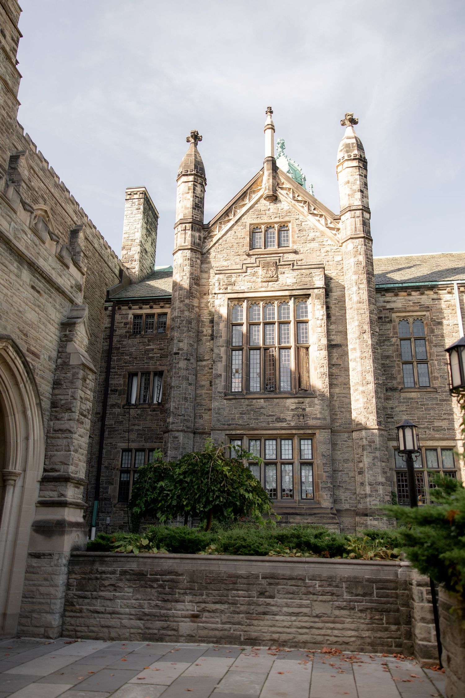 Gothic stone architecture of a university building with ornate spires and windows.