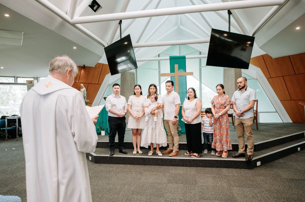 A religious ceremony taking place in a modern church setting with skylights.