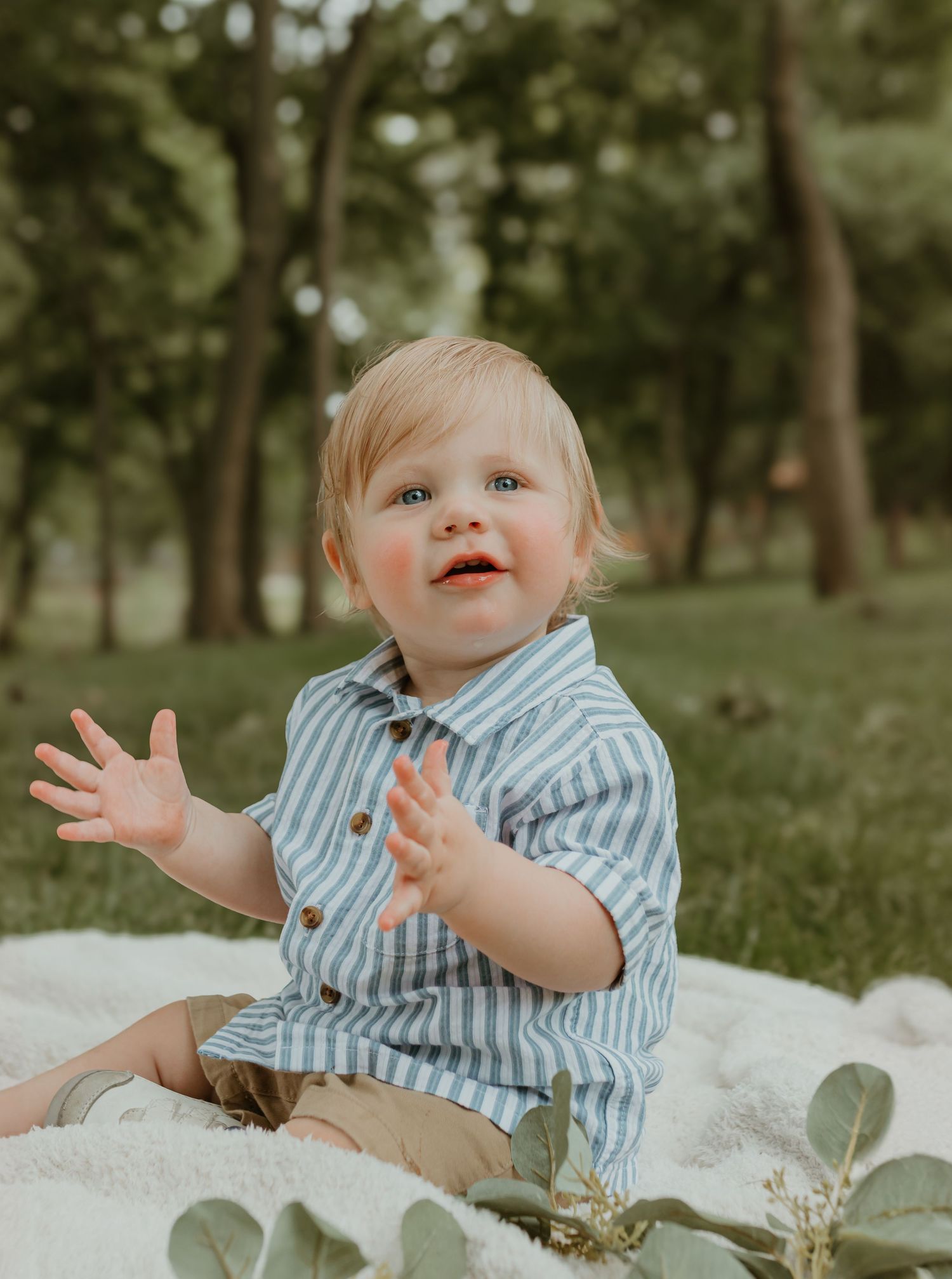 A joyful outdoor portrait session featuring animated gestures and a striped shirt. Colorado Springs Photographer.