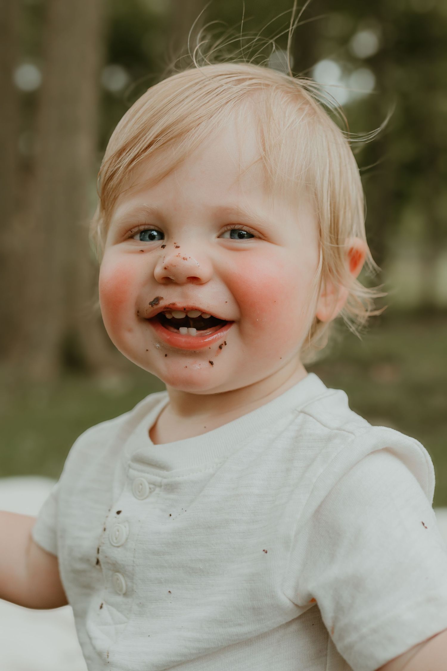 A messy cake smash portrait showing pure joy and frosting covered happiness. Colorado Springs Photographer