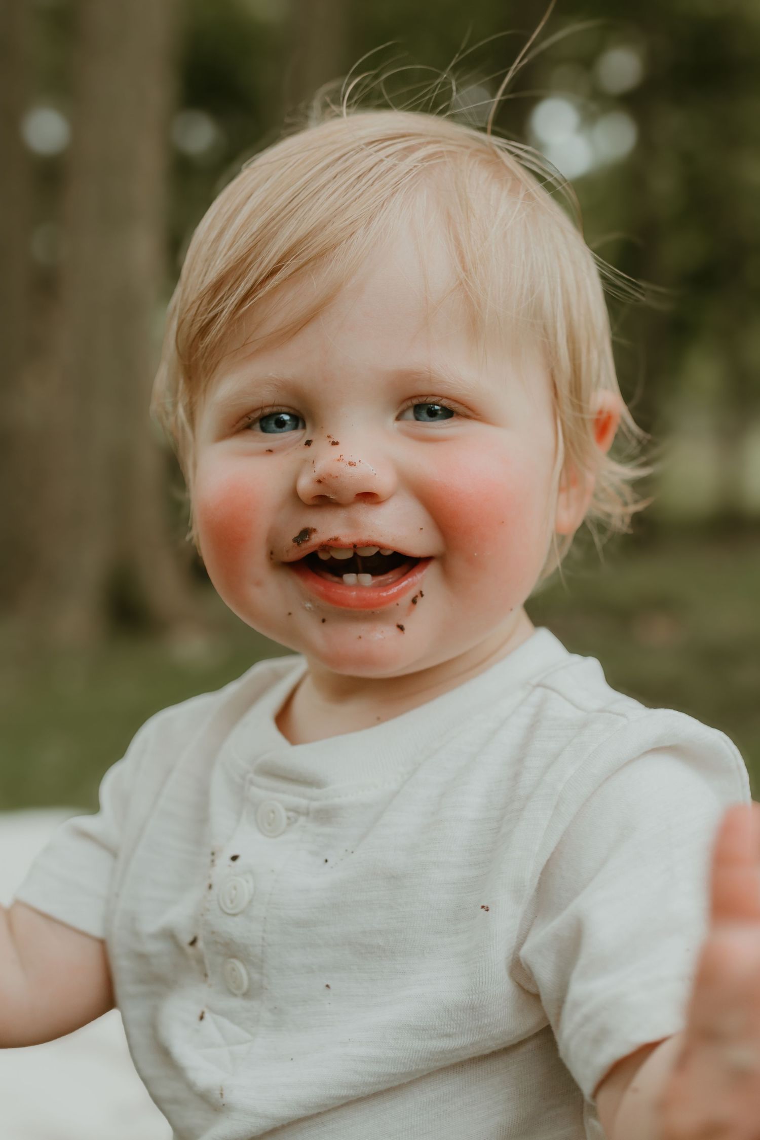 Candid moment capturing pure delight during a cake smash photo session. Colorado Springs Photographer