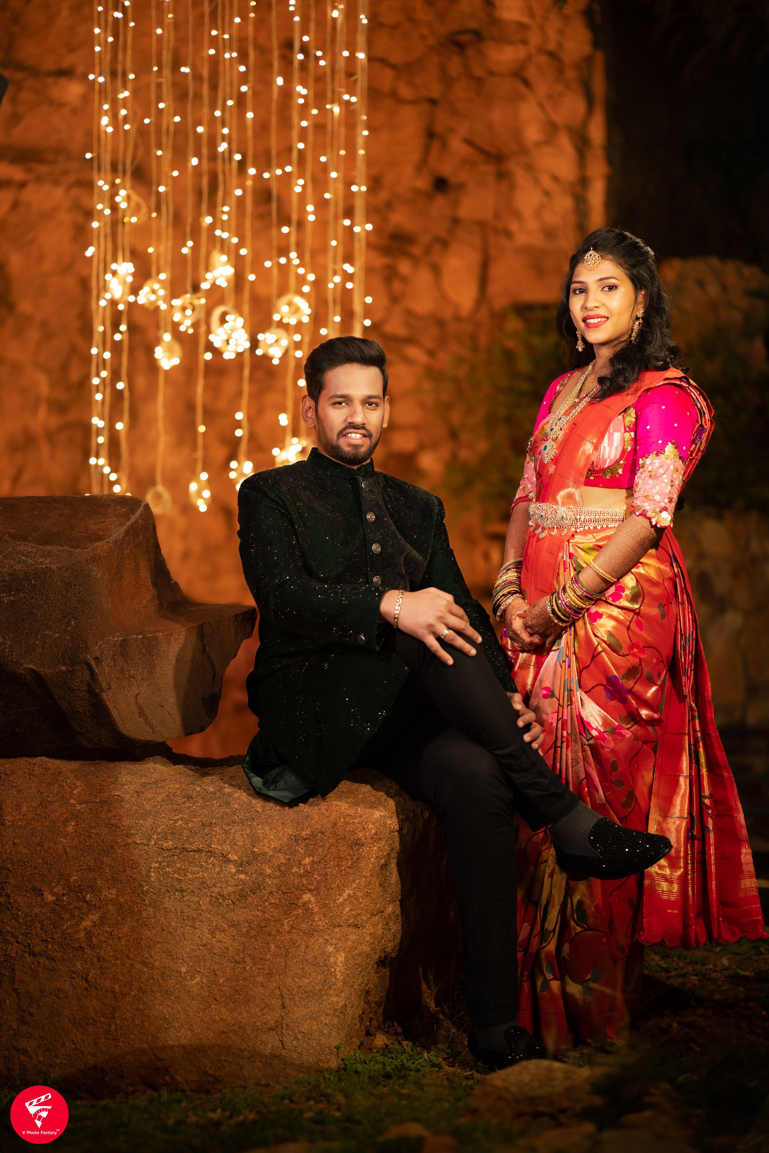 An elegant photo shoot with string lights and traditional Indian formal wear.
