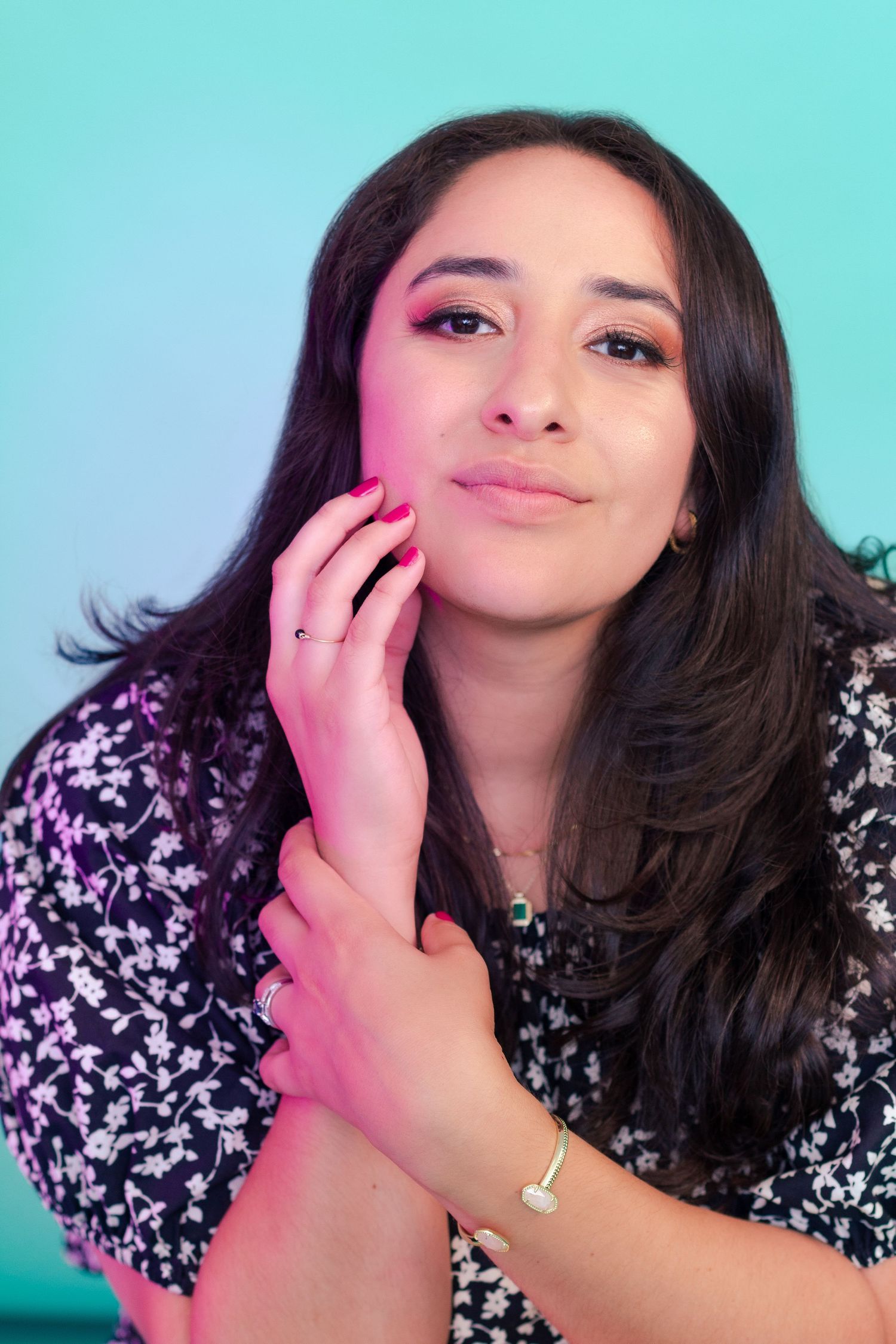 Portrait photography: portrait of a woman in a floral dress against a blue backdrop