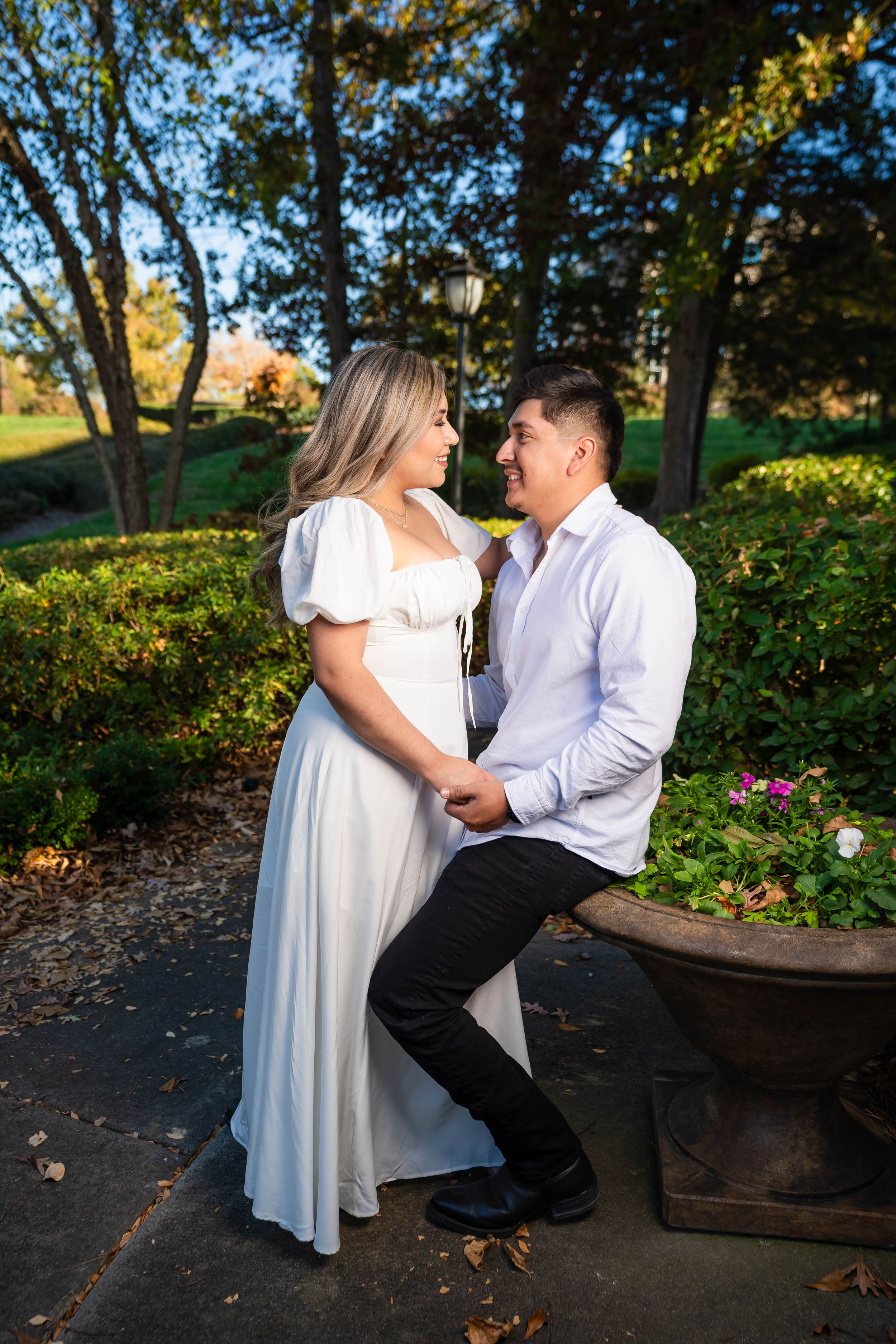 An engagement photo captured in a scenic garden during golden hour.