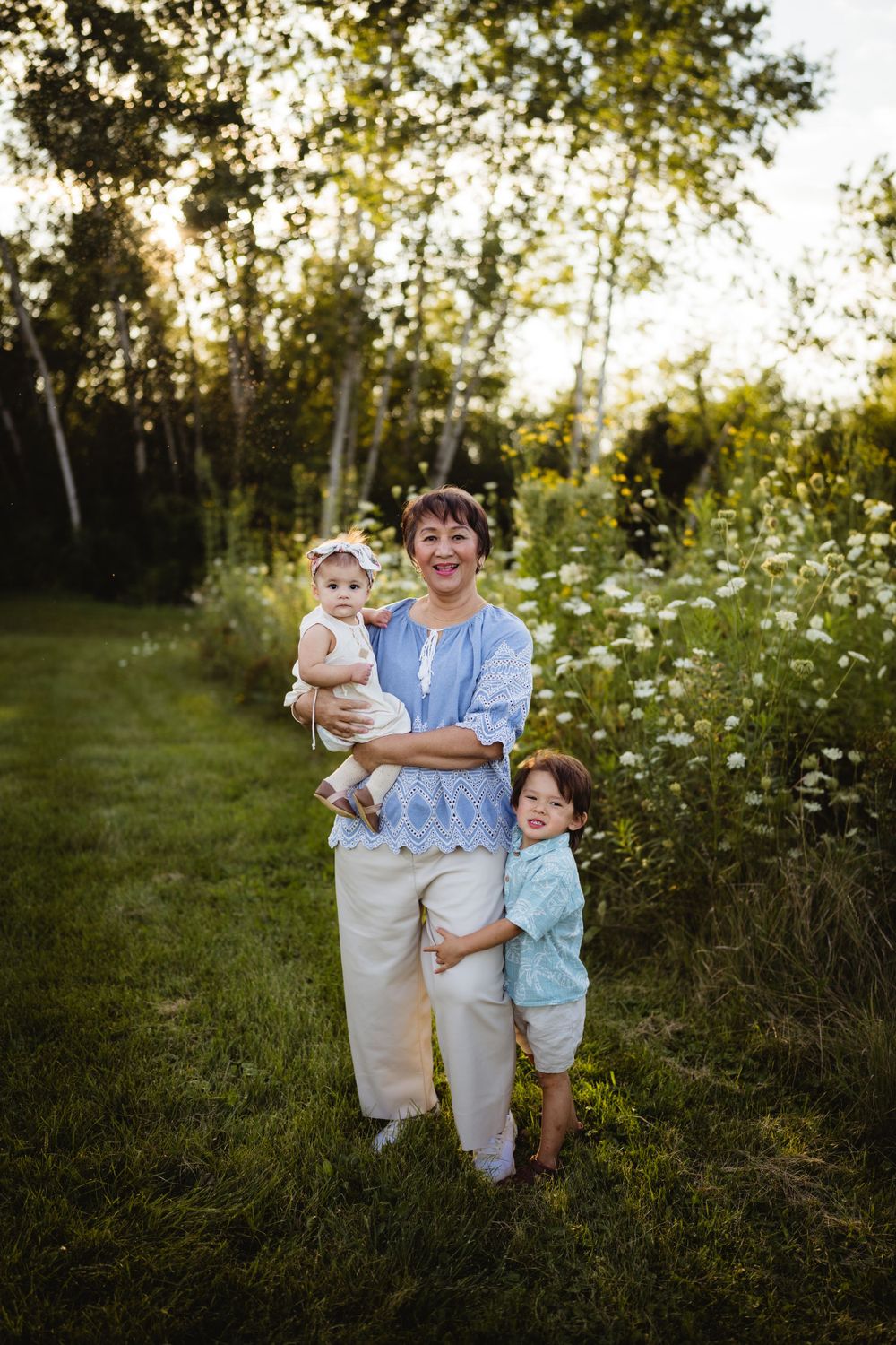 A heartwarming family moment captured in a wildflower meadow at golden hour.