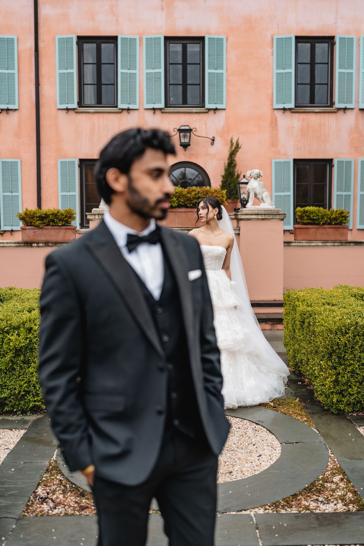 Buffalo NY wedding photographer luxury shoot with two people one in black suit and the bride behind him