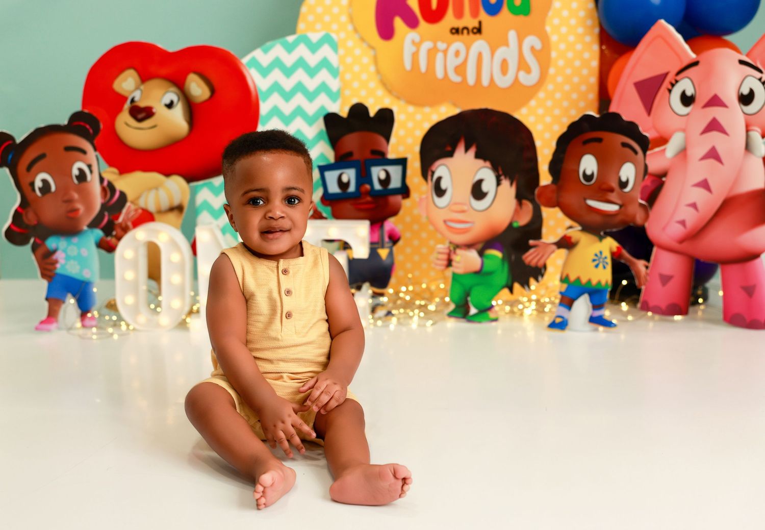 A collage of colorful toys and plush animals arranged in a row against a white background.