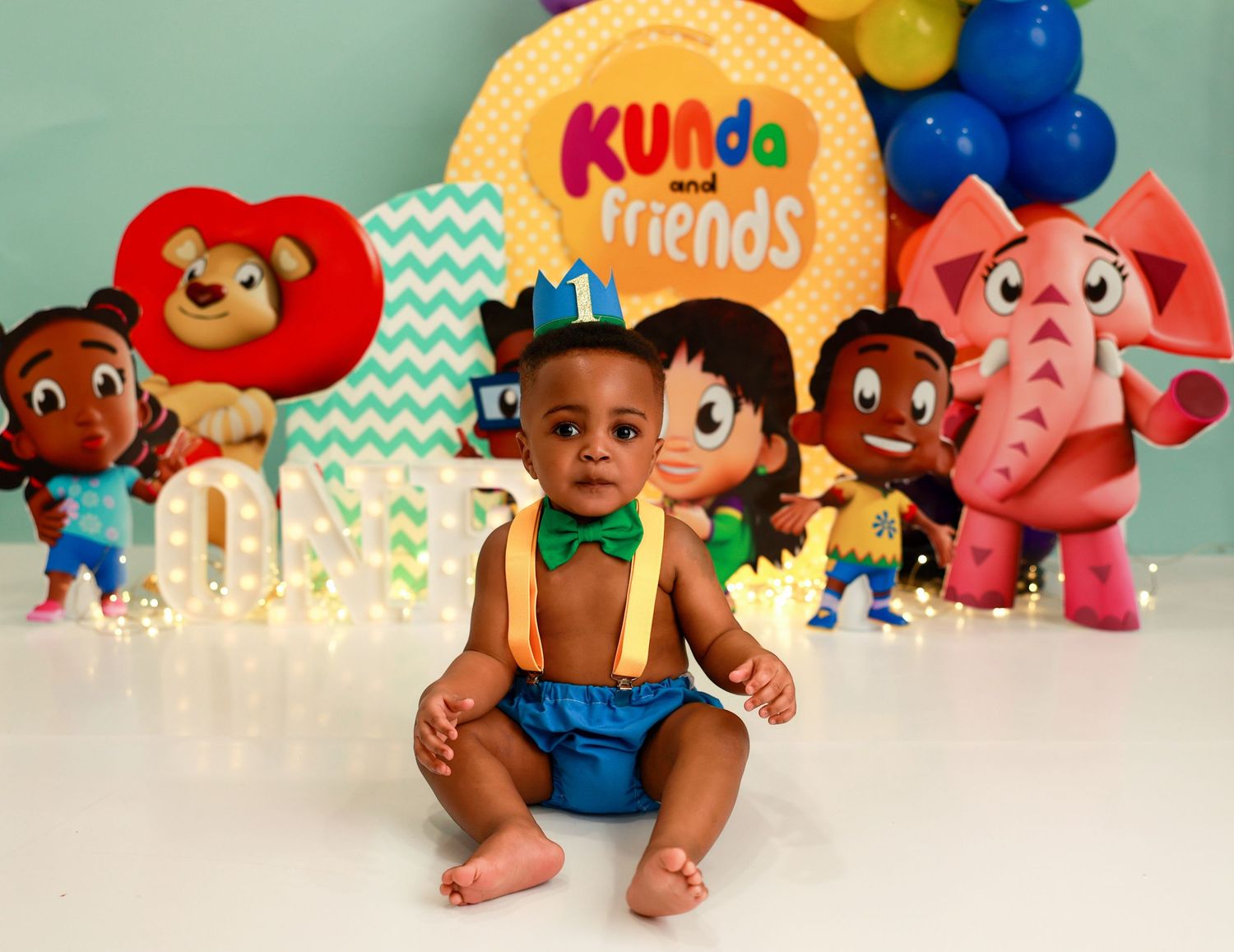 A collection of colorful toy figures and characters arranged in a row against a white background.