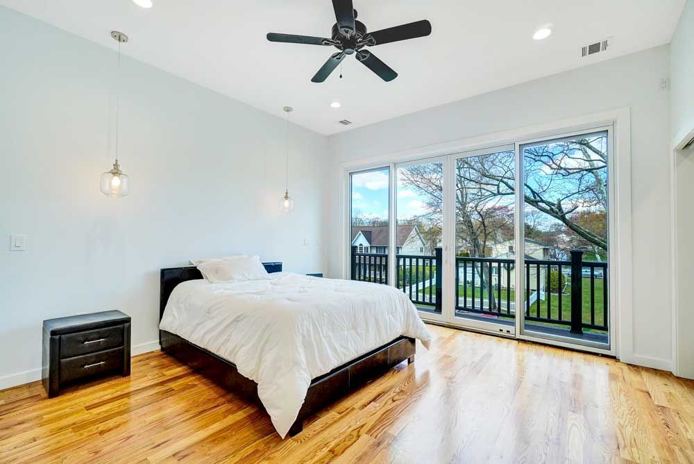 Professional Luxury Real Estate Photography Interior Bedroom with Balcony in Fall