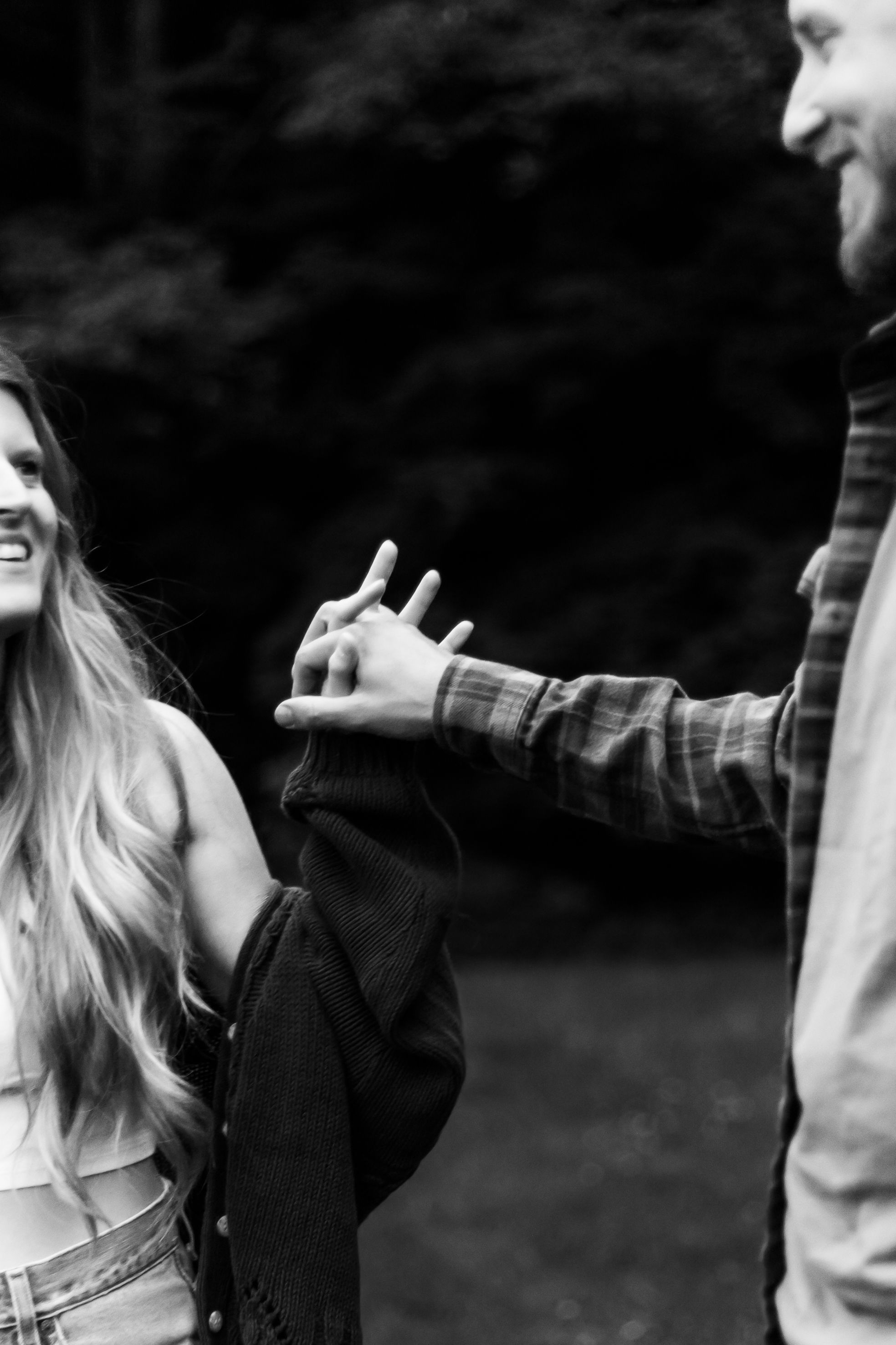 A couple dances expressively together against a dark outdoor background.
