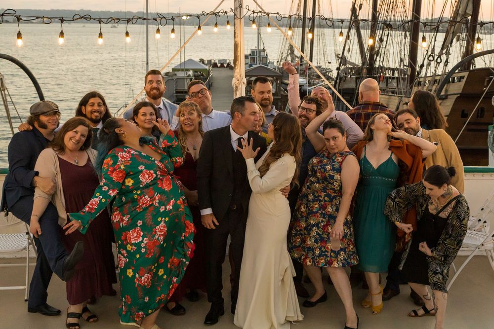 Wedding guests posing in candid celebration photos at an outdoor venue by Zeus Holbrook Wedding Photographer
