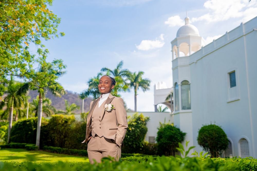White church building with palm trees and blue sky in Riu Palace, Costa Rica