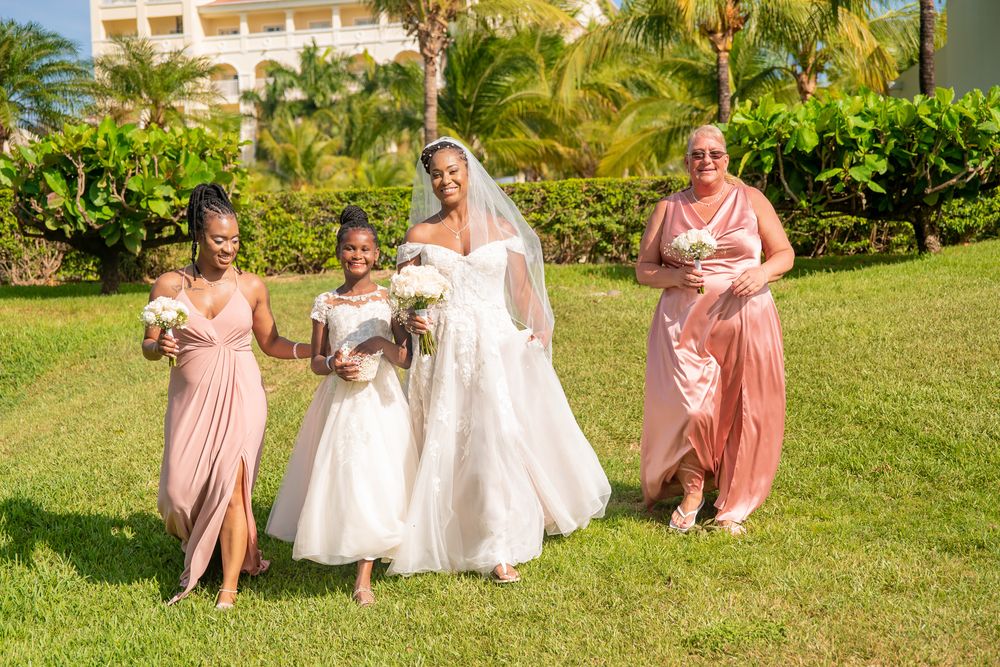 Wedding party in pink dresses in photoshoot at sunset on the beach in Riu Place, Guanacaste, Costa Rica
