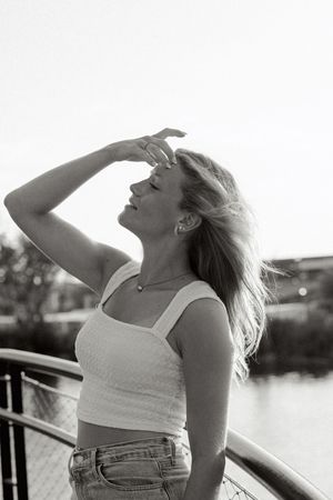 Black and white waterfront photoshoot capturing carefree summer moments at sunset.