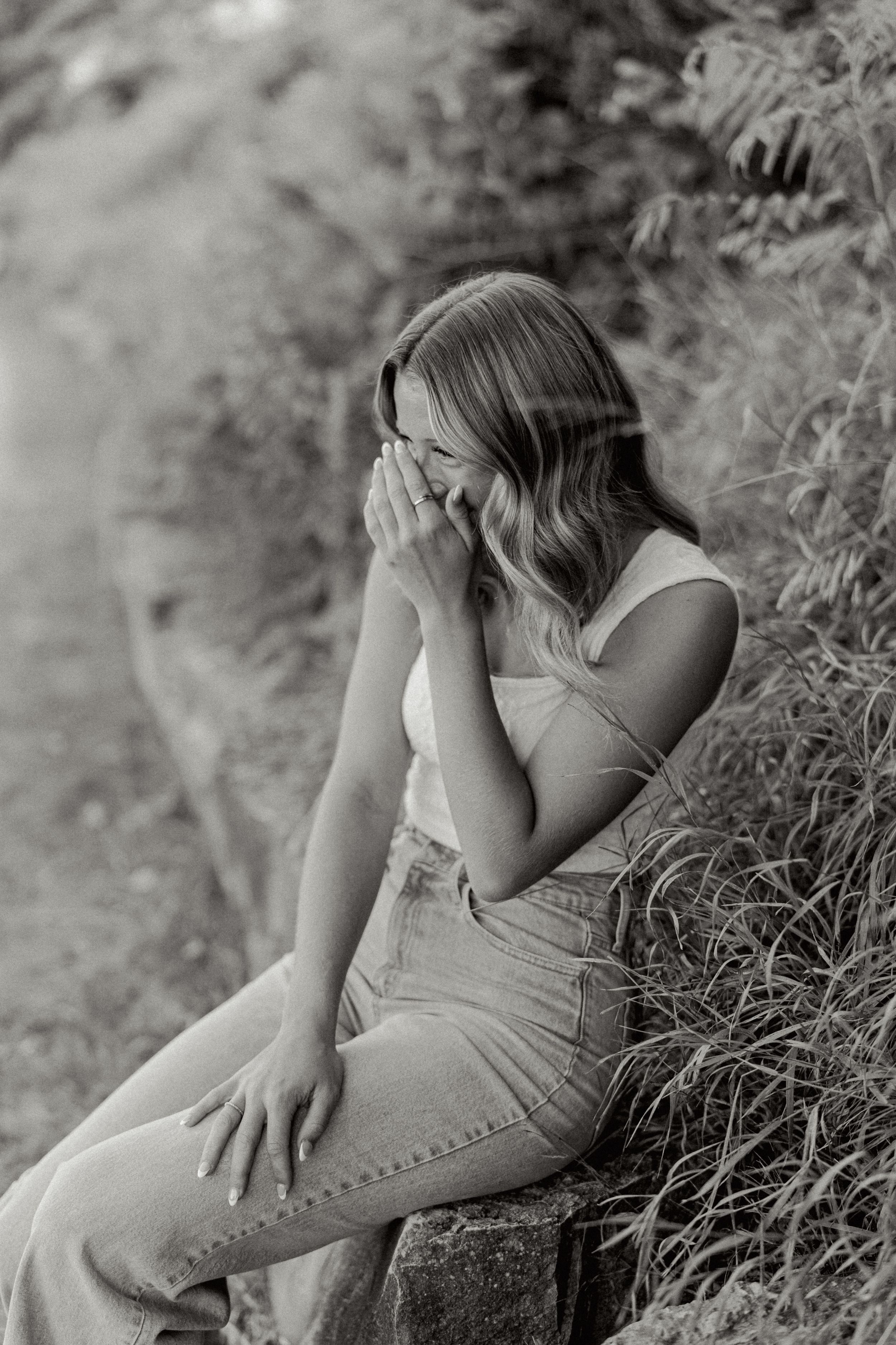 Black and white artistic portrait among natural foliage.