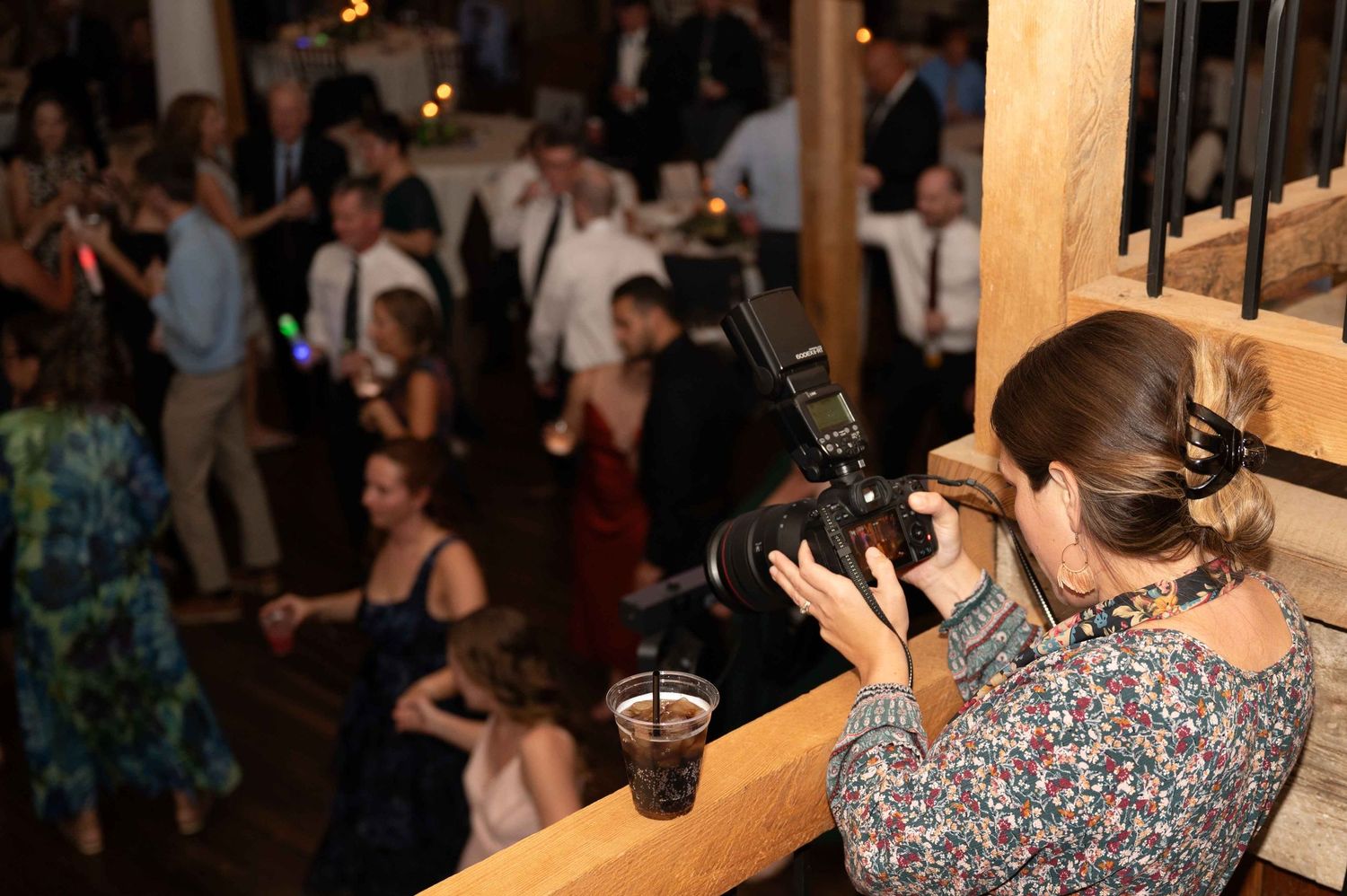 Dancers moving energetically on a wooden dance floor at a lively social gathering or party.