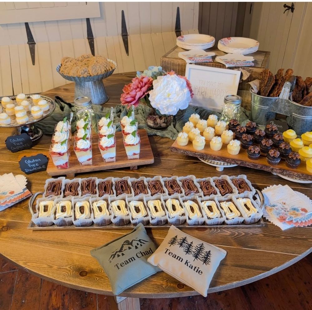 Elegant dessert table spread with assorted pastries, mini trifles, and bite-sized treats on display.