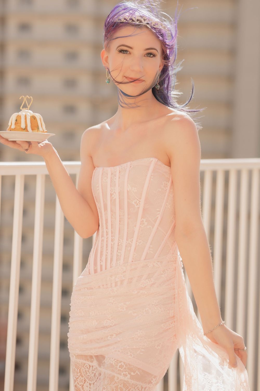 A series of photos showing a person in a pink strapless dress with a purple hair accessory posing outdoors.