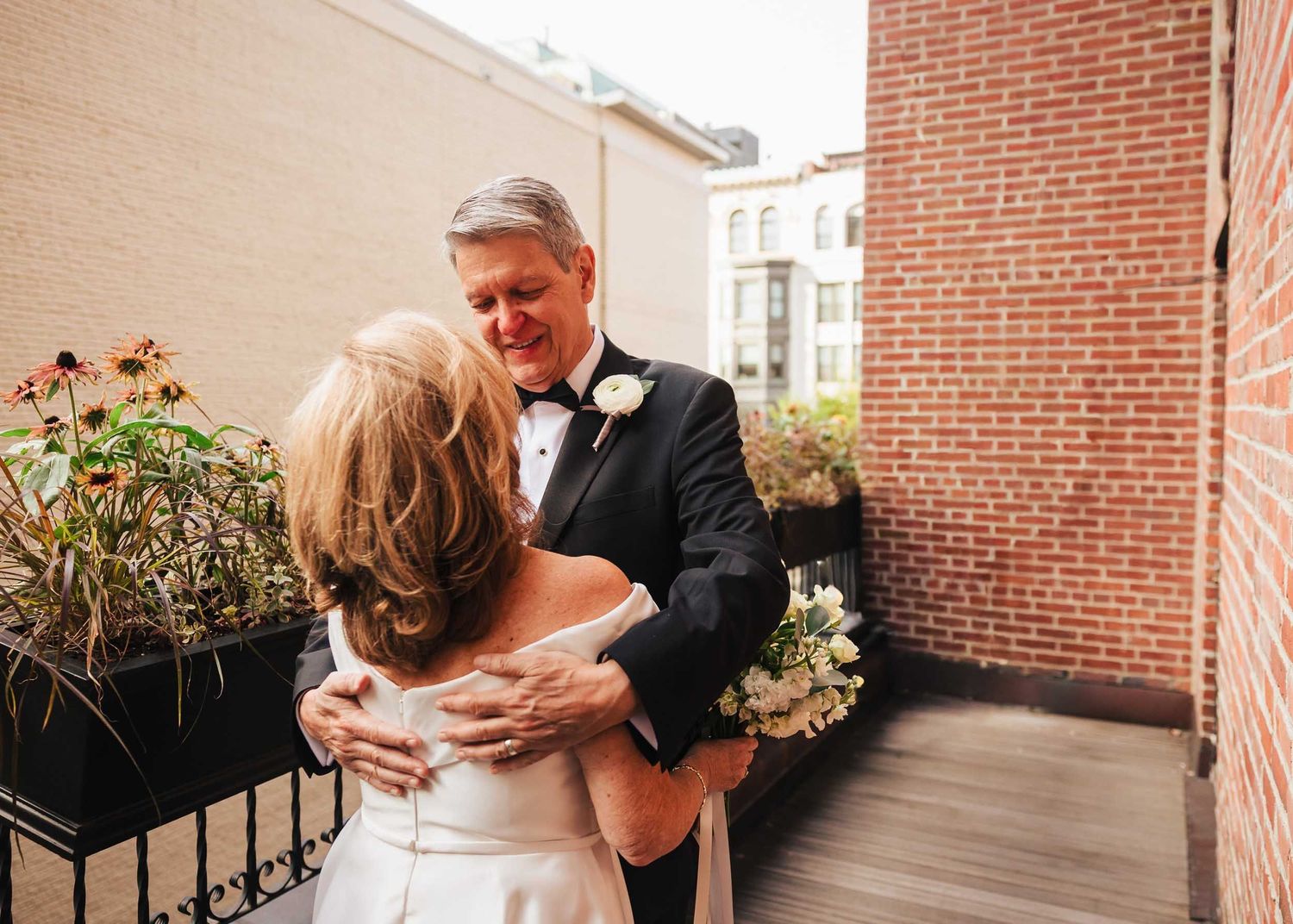 Father embracing bride during emotional first look moment at Lenox Hotel Boston wedding