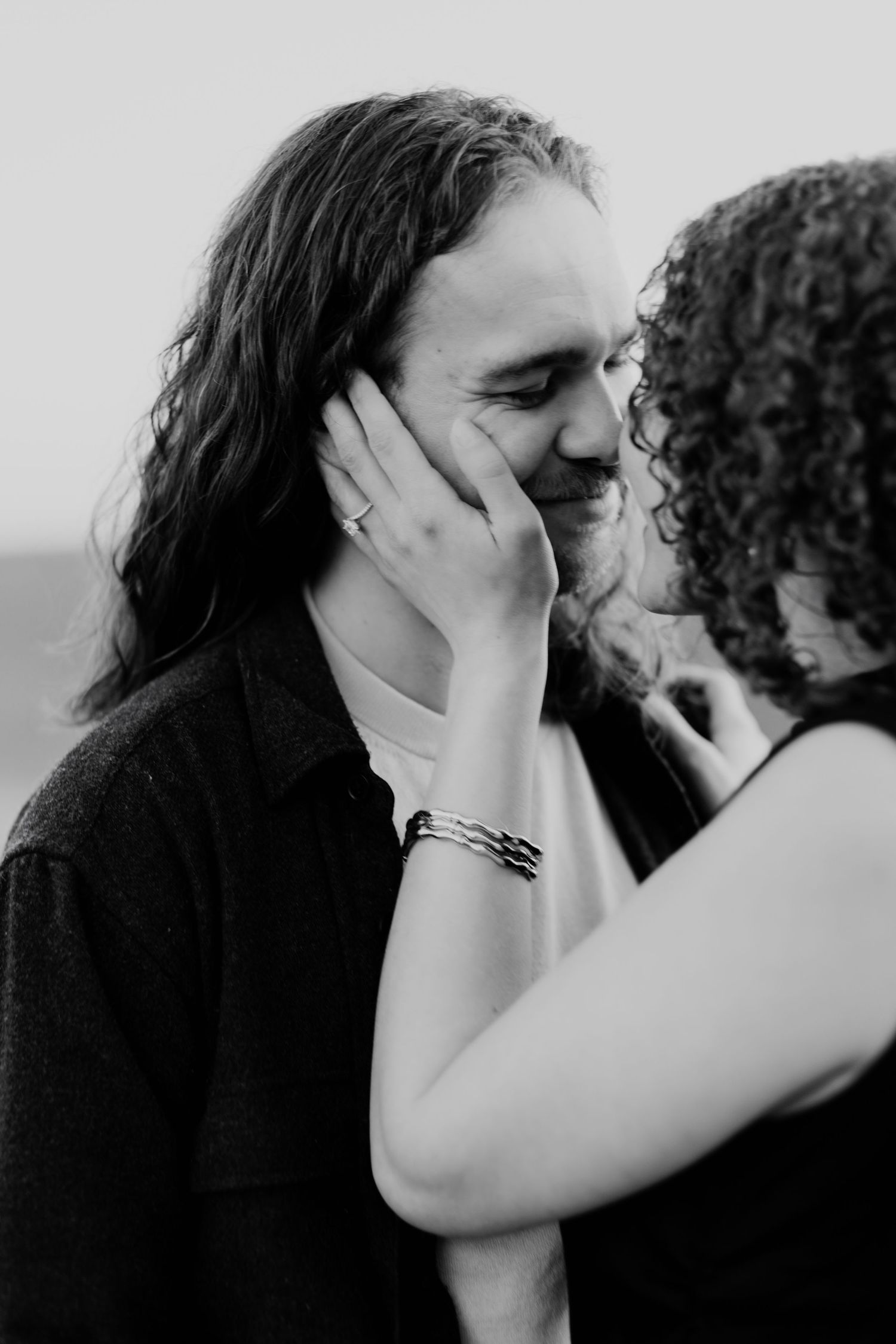 Intimate black and white photo sequence of a couple sharing tender kisses and embraces.
