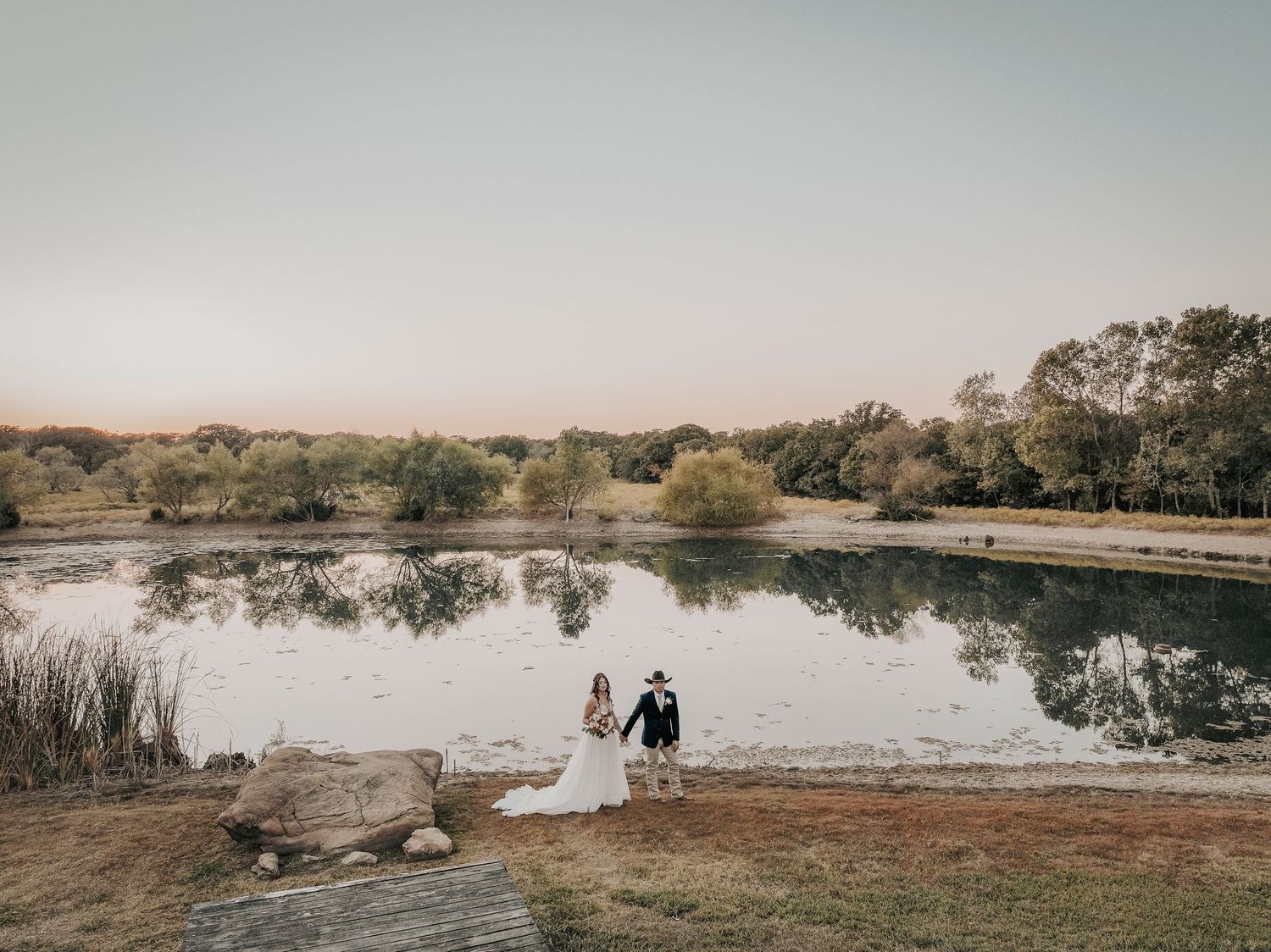 Bride and groom kissing at sunset at The Barn at Paradise