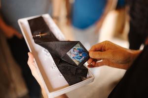 A sequence of photos showing hands opening a white box containing a blue card or device inside.