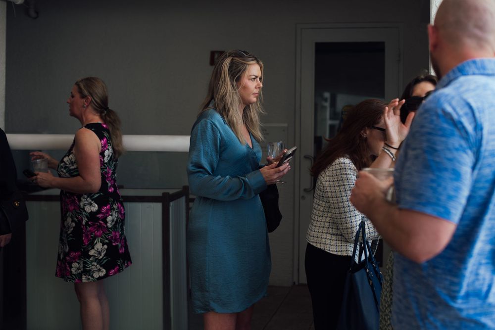 Group of business professionals networking in a modern venue during a corporate event.