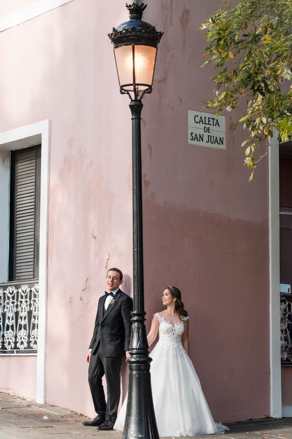 Bride and groom portrait against colorful wall in Old San Juan destination wedding