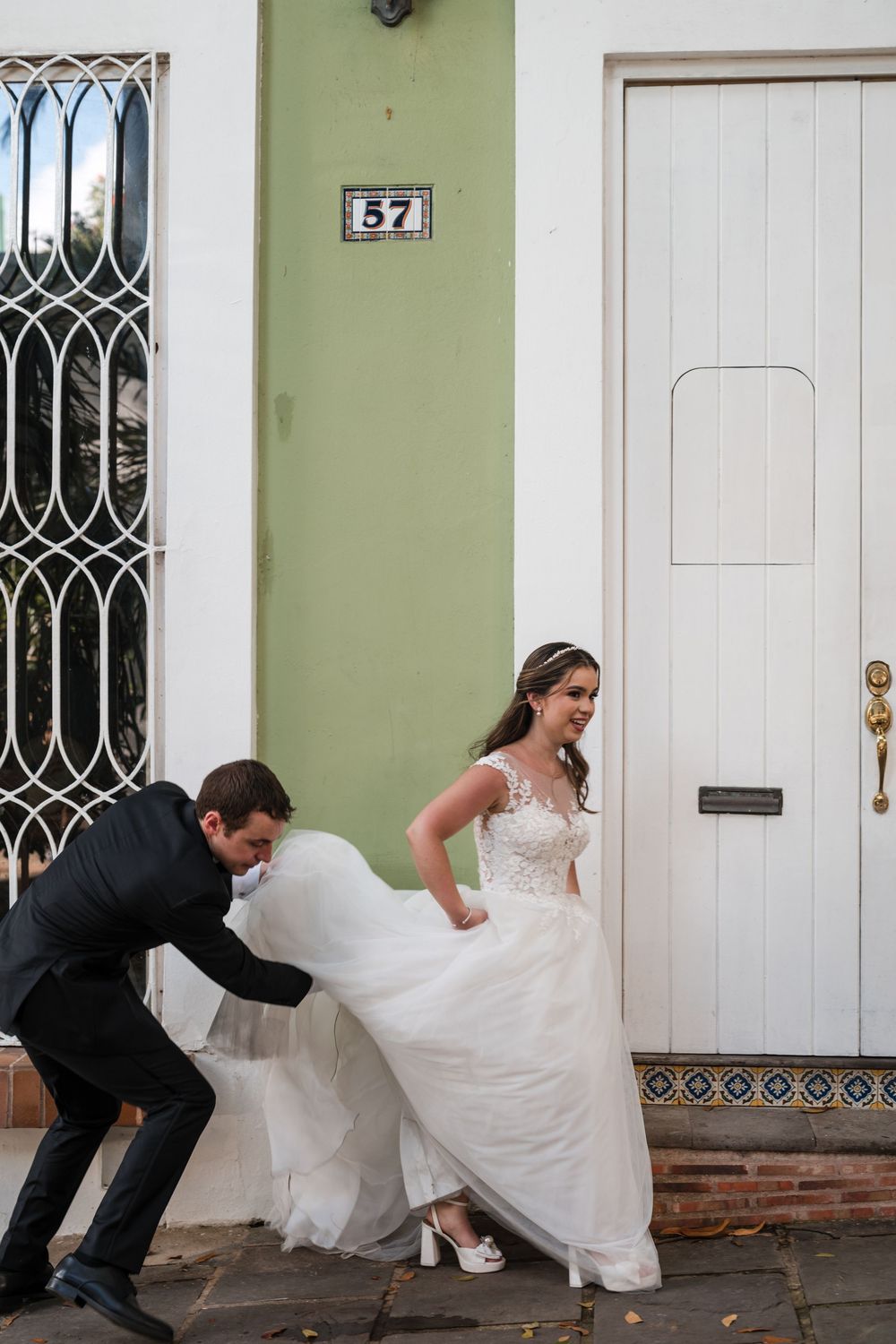 Bride and groom walking together on cobblestone street in Old San Juan Puerto Rico
