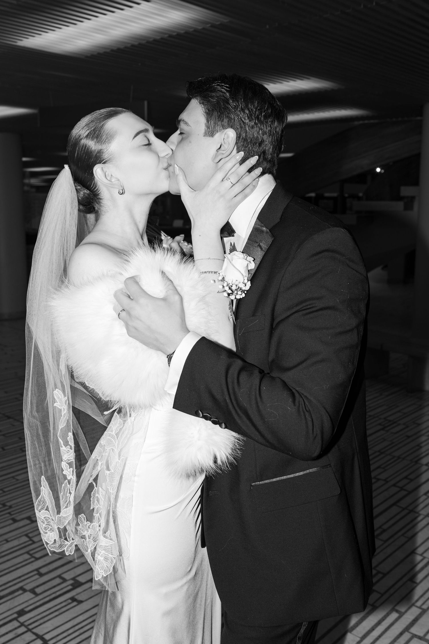 Newlywed couple embraces in golden sunset light while sharing intimate moments in an outdoor setting.