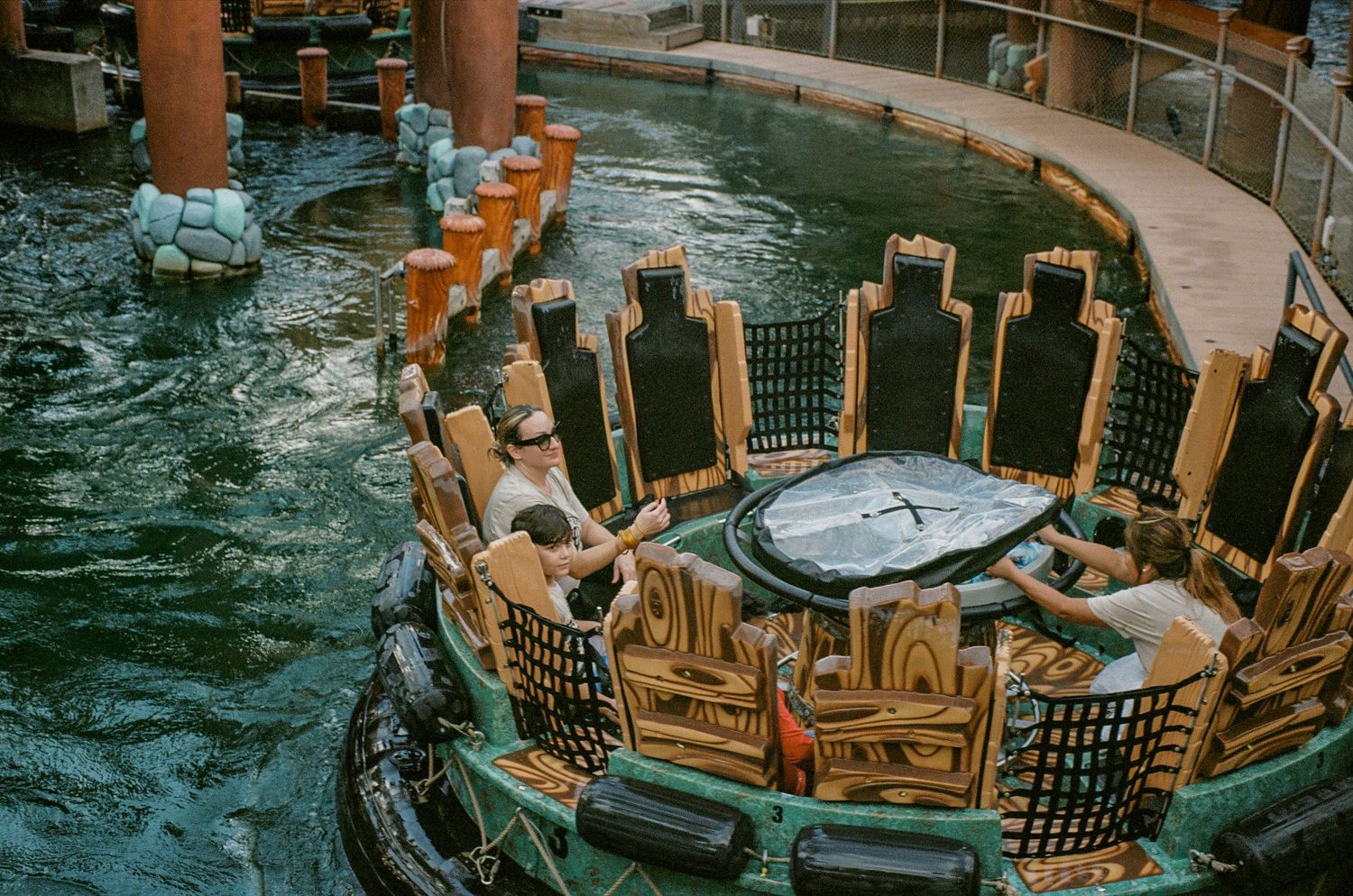 Theme park water ride with decorative cityscape design and splashing effects.