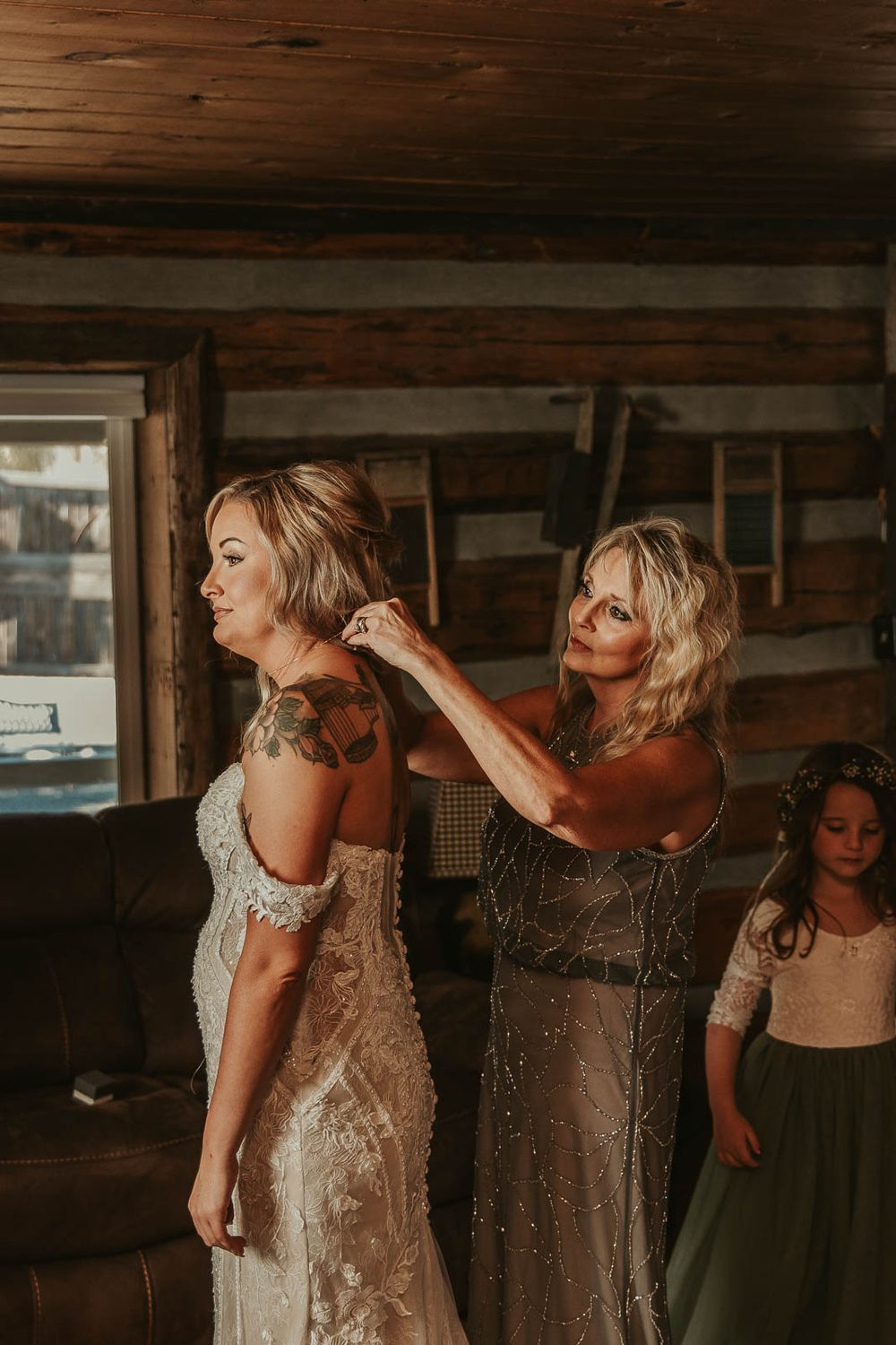 Jessica’s final touches lace gown, delicate jewelry, and joyful anticipation with bridesmaids and mom of bride. Yakima wedding photographer